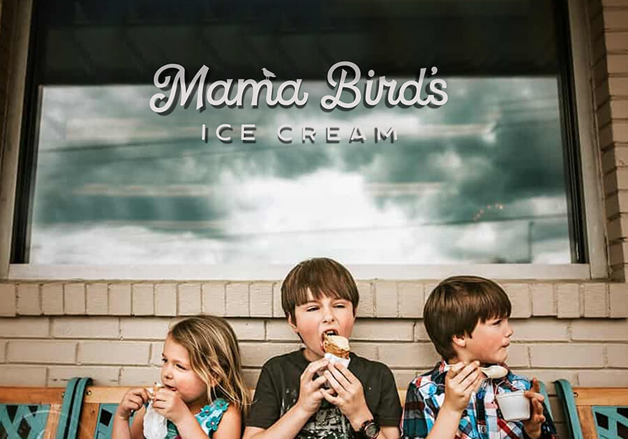 Kids enjoy their ice cream in front of Mama Bird's Ice Cream.